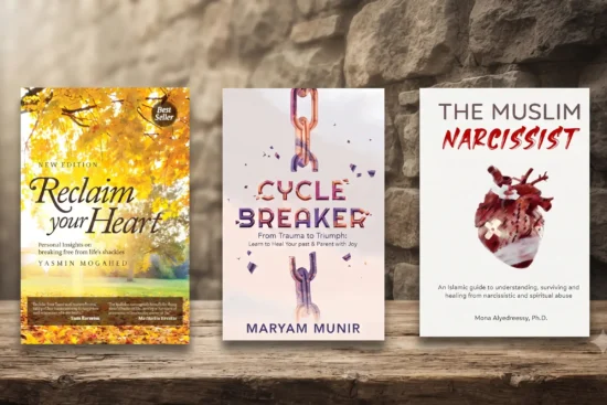 A flat-lay photograph featuring three influential self-help and spiritual growth books arranged side-by-side on a rustic wooden table against a textured stone wall background. The books displayed are 'Reclaim Your Heart' by Yasmin Mogahed, which explores breaking free from life’s shackles; 'Cycle Breaker' by Maryam Munir, a guide for healing from trauma and mindful parenting; and 'The Muslim Narcissist' by Mona Alyedreessy, an Islamic guide to understanding and healing from narcissistic abuse. The image serves as a thematic collection for readers interested in personal development, emotional healing, and faith-based self-improvement.