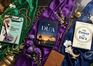 Luxury flat-lay of three Islamic books—The Productive Muslim, Du'a, and The Power of Du'a—arranged on emerald, violet, and blue silk over a black marble table with prayer beads and lanterns.